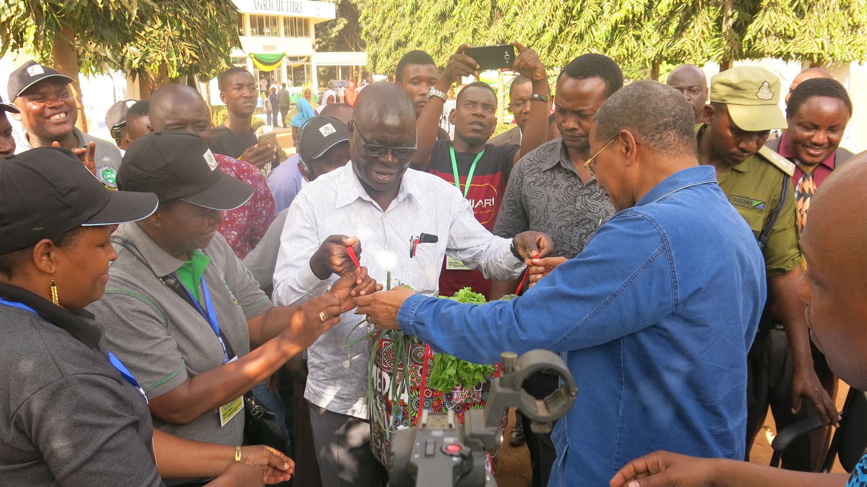 Kikwete receiving basket full of vegetables and fruits produced at Sokoine University of Agriculture