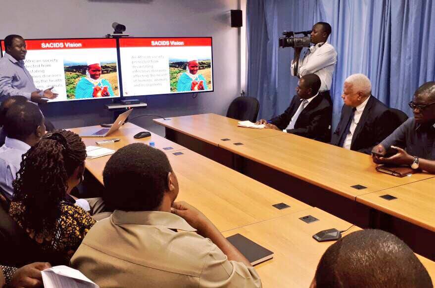 Hon.Mohamed Othman Chande visiting Southern African Centre for Infectious Disease Surveillance (SACIDS).Centre leader Prof. Gerald Misinzo giving explanations about the projects function vision and mission