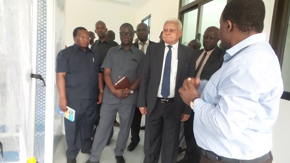 Hon. Mohamed Chande Othman being briefed by Prof. Gerald Misinzo about function of the Molecular Biology Laboratory in the College of Veterinary Medicine and Biomedical Sciences